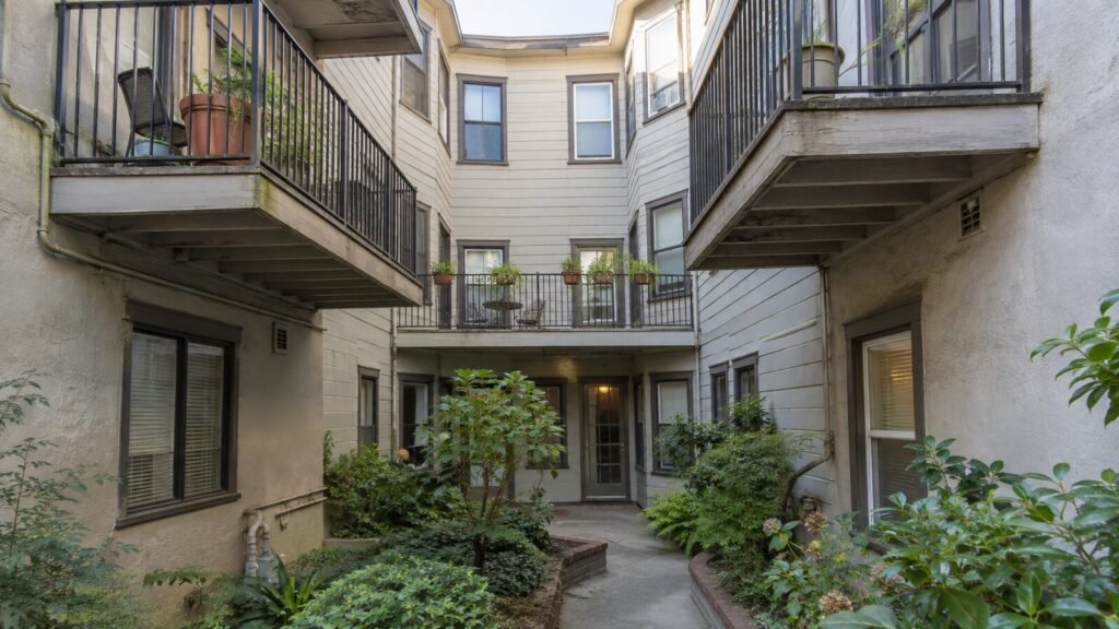 Cantilevered wood balconies in the courtyard of a San Francisco flats building, subject to Section 604 inspection