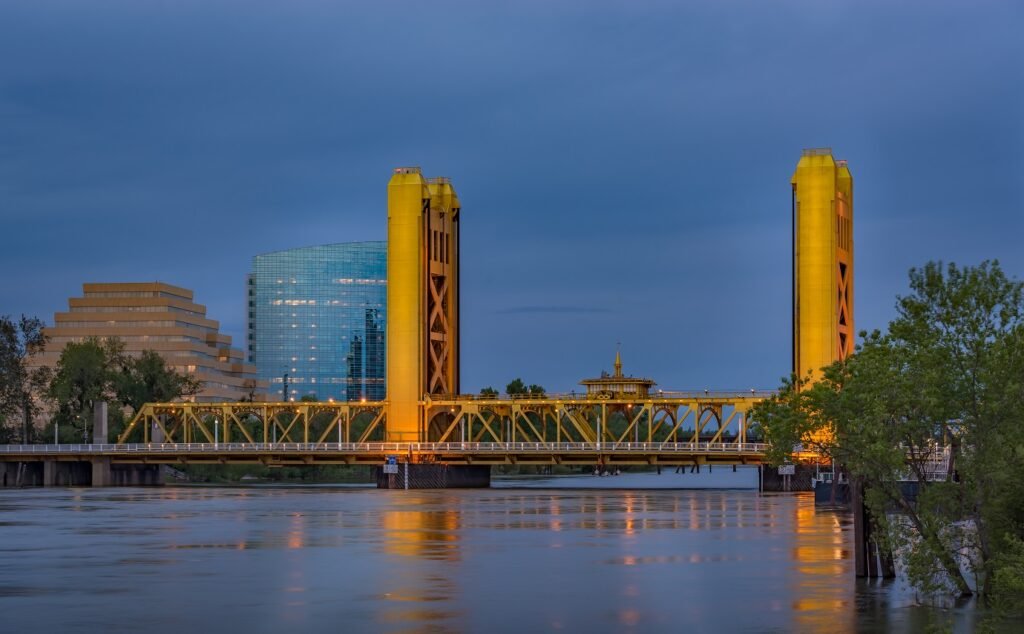 Tower Bridge over the Sacramento River with the Ziggurat Building in West Sacramento, CA at dusk — landmark in ABD Inspections Yolo County deck and balcony service area