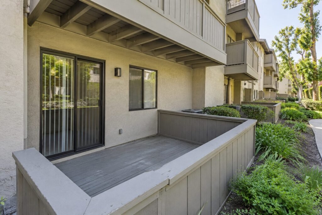 Enclosed ground-level deck with solid half-wall at a Sacramento condo, a routine deck inspection stop