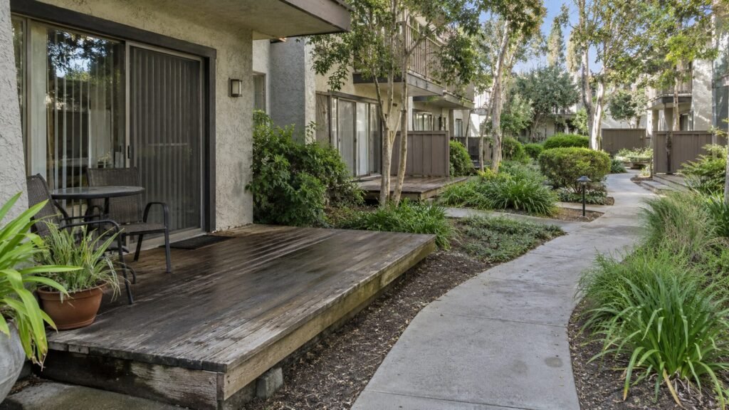 Weathered ground-level wooden deck with patio furniture at a Sacramento condo, a typical deck inspection site