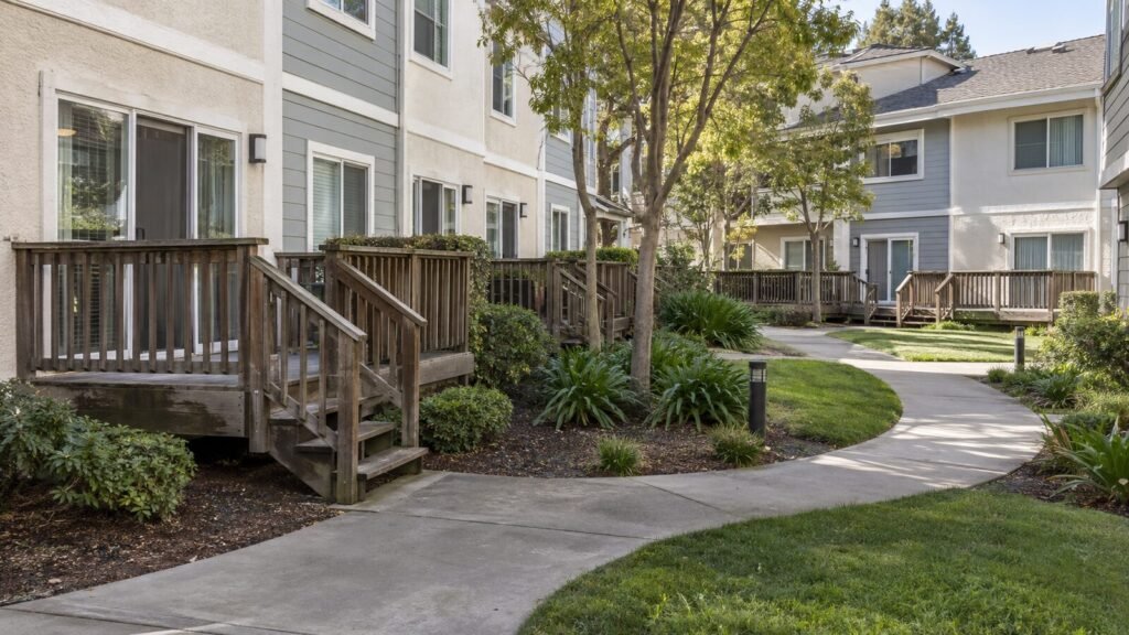 Row of raised wooden decks with railings and stairs at a Sacramento multi-family community awaiting deck inspection