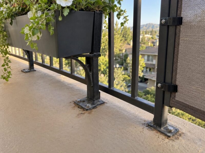 Bolted planter brackets creating unflashed penetrations through a balcony membrane