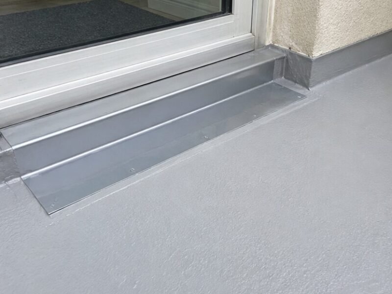 New threshold pan flashing and membrane installed at the balcony door