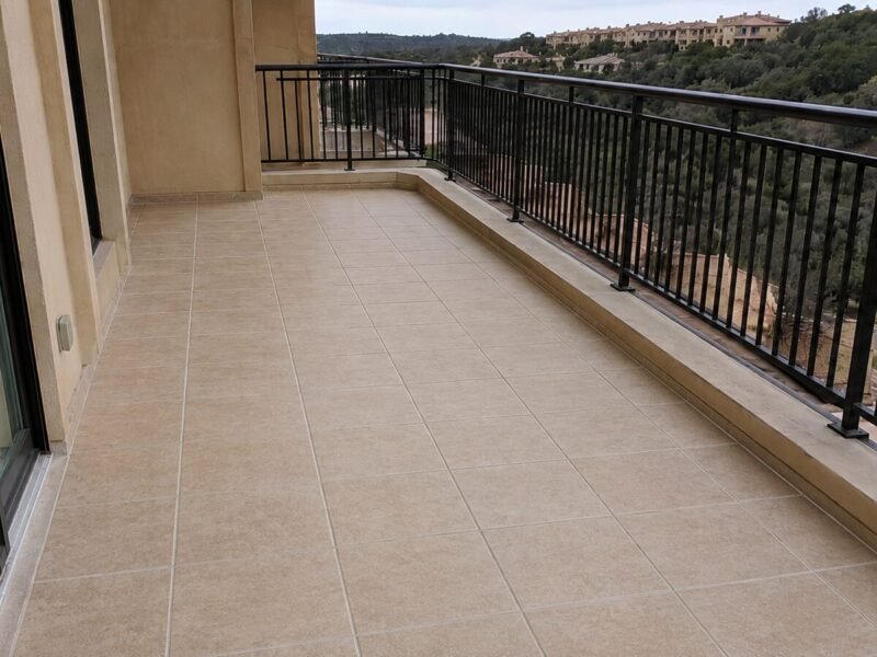 Completed balcony with new membrane, pan flashing and reset tile