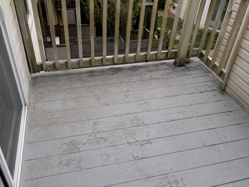 Chalked and worn balcony coating at a Woodland condominium before recoating