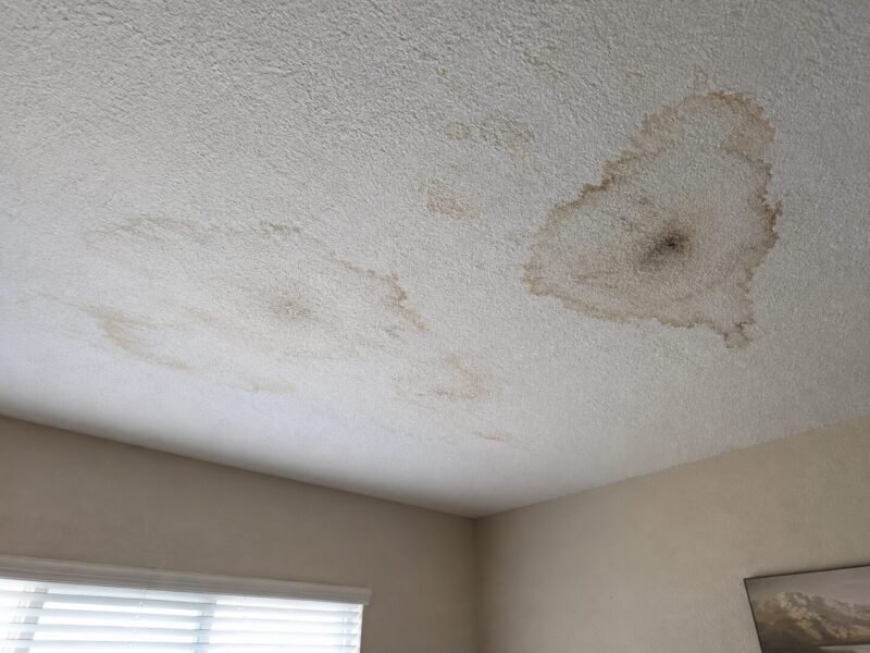 Water-stained ceiling in a ground-floor Tracy apartment beneath a leaking balcony