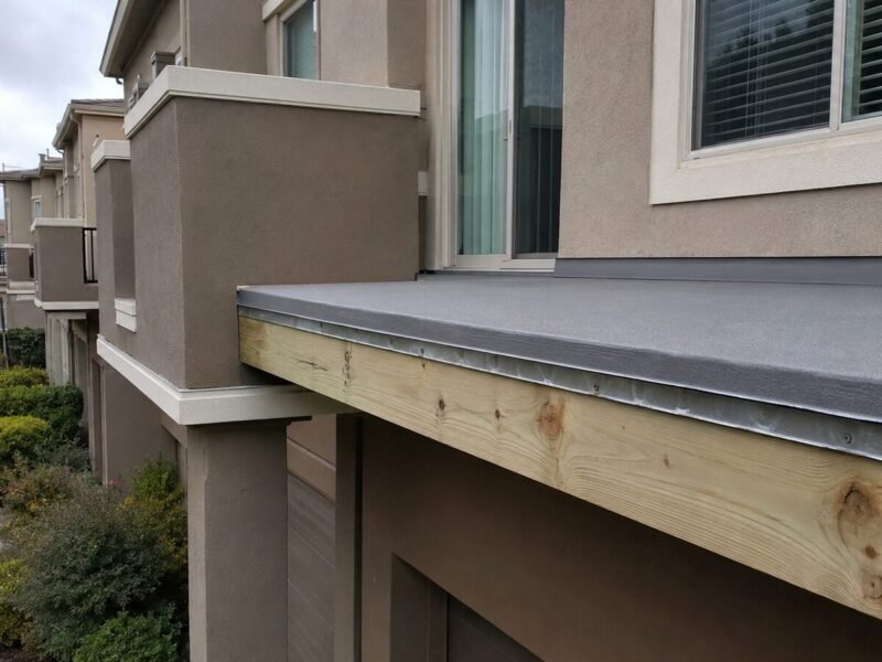 Replaced pressure-treated rim joist with new edge metal set under the membrane