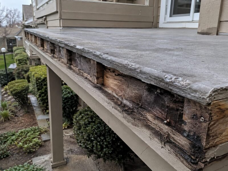 Deck edge fascia removed, showing a water-damaged rim joist