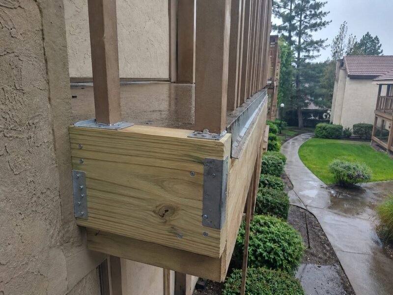 New pressure-treated rim joist and Simpson connectors installed before waterproofing
