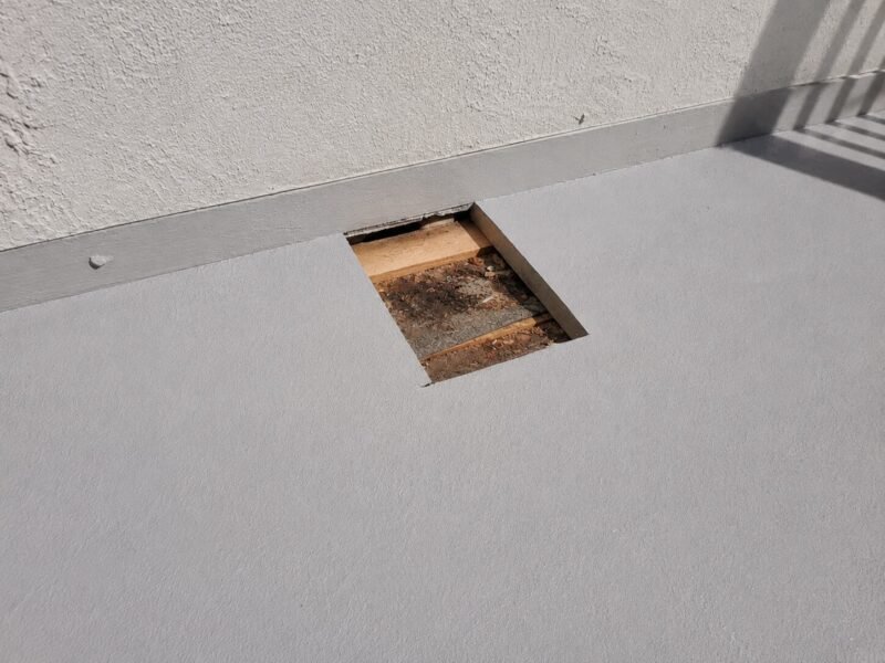 Exploratory opening cut in a west-facing balcony deck during an SB 721 inspection in Vacaville