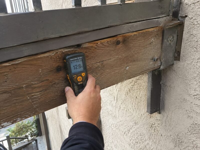 Moisture meter reading taken at a balcony ledger during a Vacaville SB 721 inspection