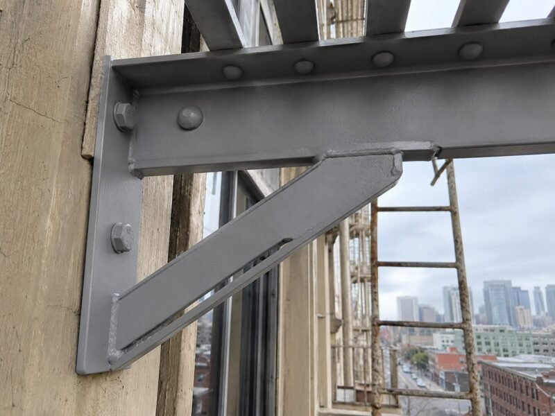 Rebuilt galvanized steel fire escape landing after repair and recoating