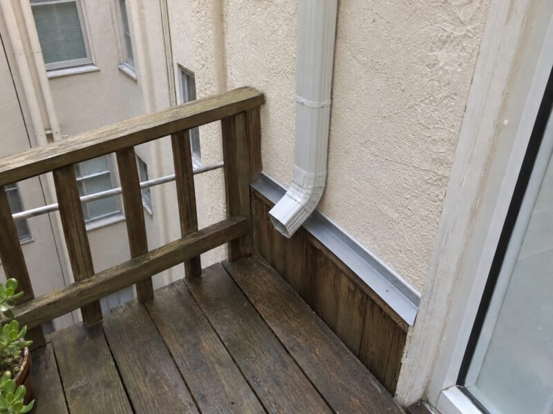 Extended downspout and re-flashed balcony ledger in the hotel light well